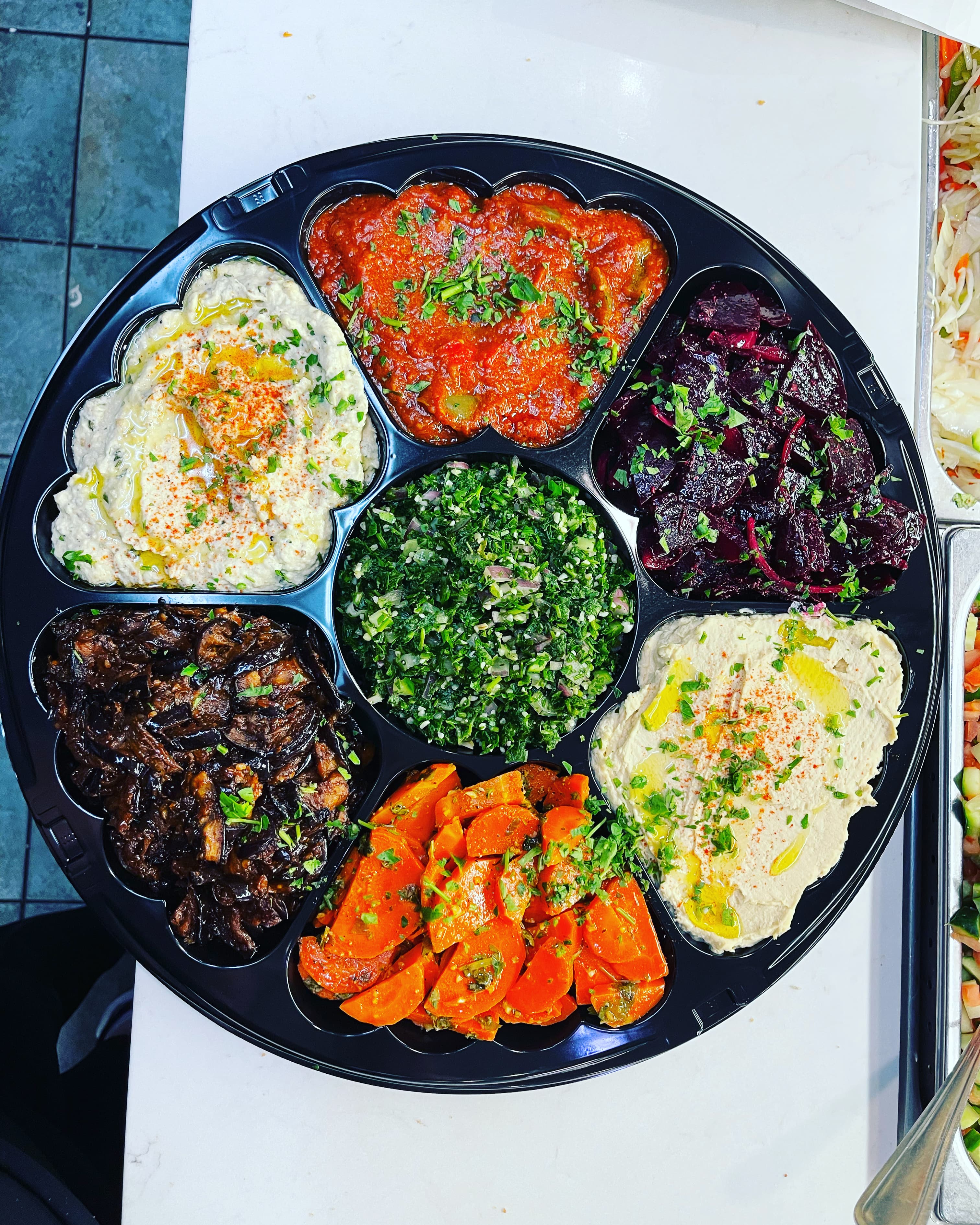 Fresh Middle Eastern spread with hummus, laffa, and Israeli salad